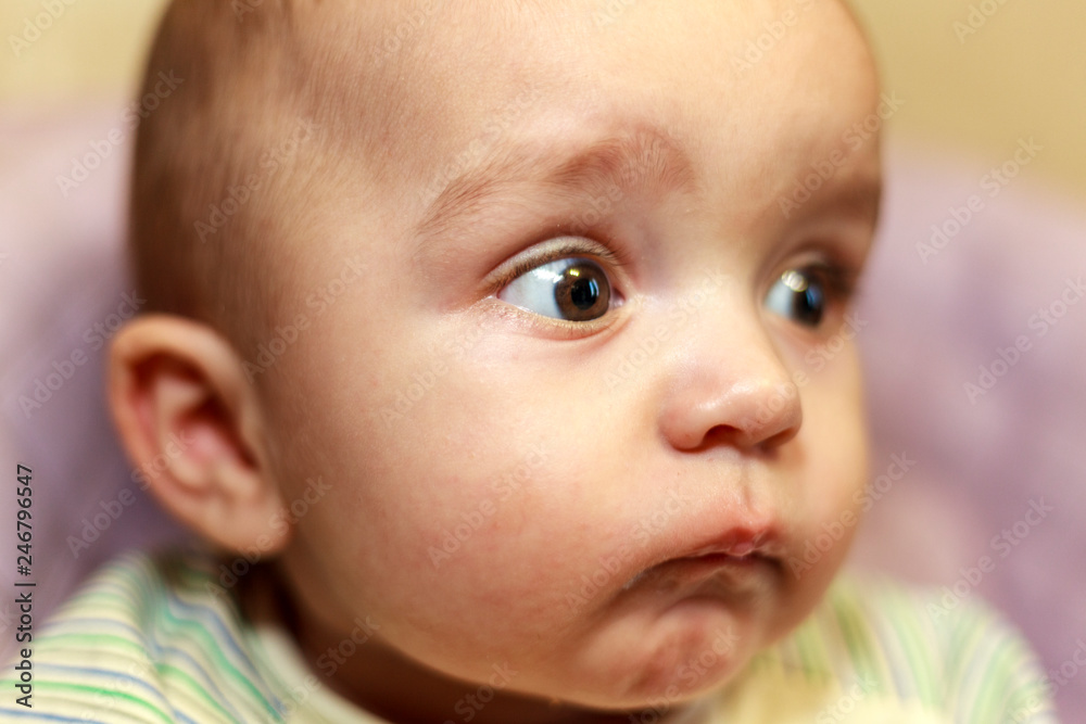 Emotions baby close up, surprise, delight, big bulging eyes;Portrait of a cute baby, facial expression and emotions