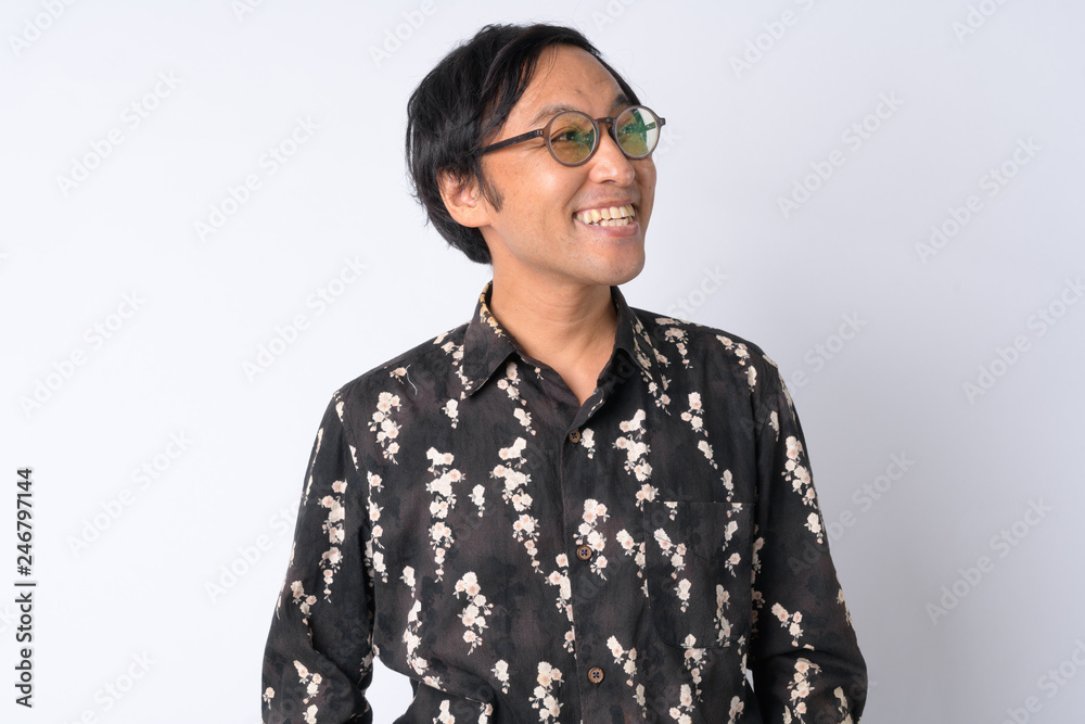 Portrait of happy Japanese businessman with eyeglasses thinking Portrait of happy Japanese businessman with eyeglasses thinking