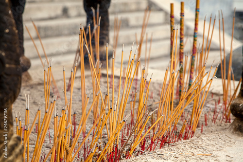  White GuanYin statue in Nanshan Buddhist Cultural Park, Joss sticks. Burning incense sticks. A close up of burning incense sticks,  photo
