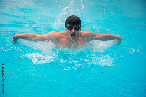 The young man swims sports style. Young guy swims with a batery © evgenii