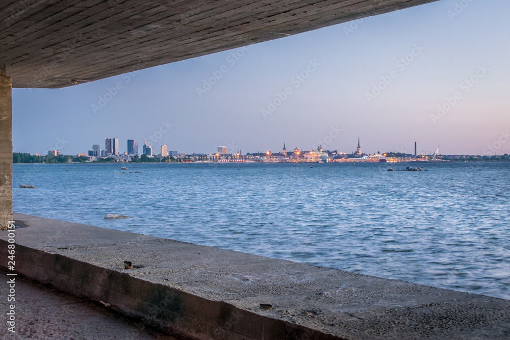 a view of a city and the sea framed in concrete . 