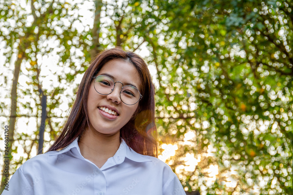 Portrait of asian college woman smiling in blur background witn sunset. Portrait of asian college woman smiling in blur background witn sunset.