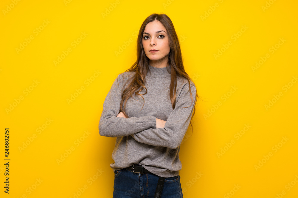 Young woman over yellow wall portrait Young woman over yellow wall portrait