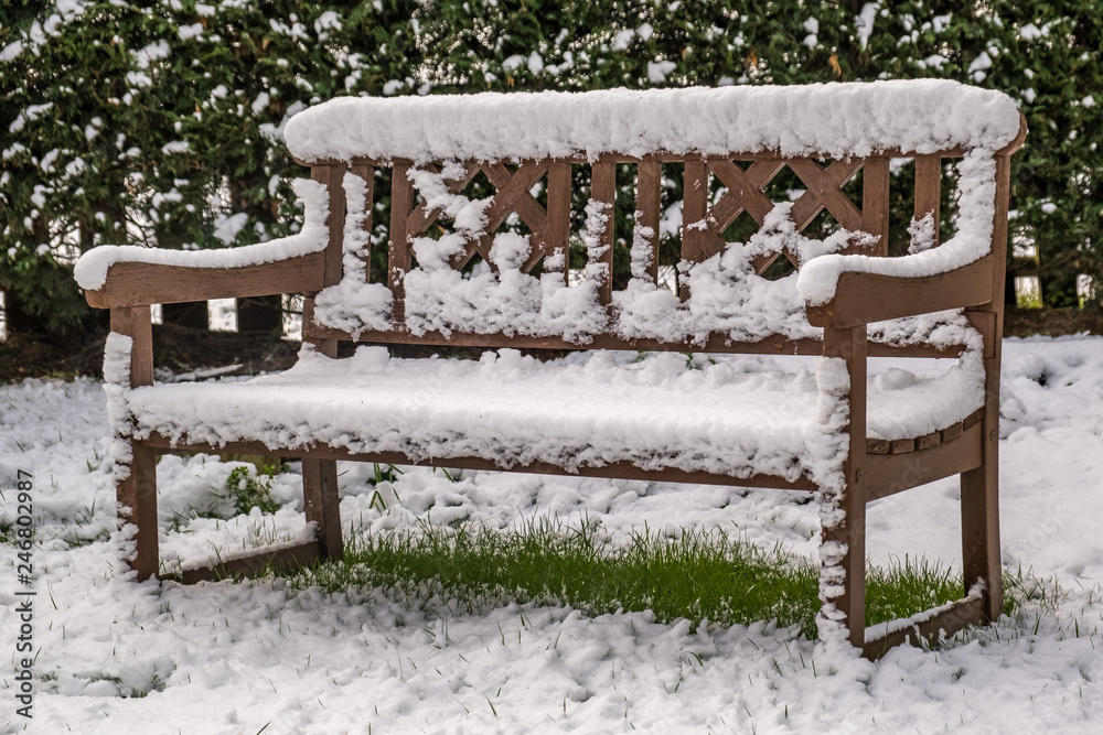 Garden bench covered in snow.