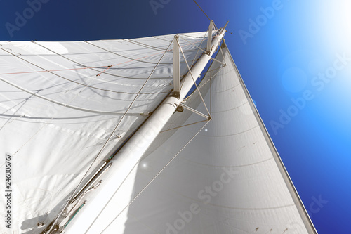 mainsail on board of a catamaran , blue ssky background photo