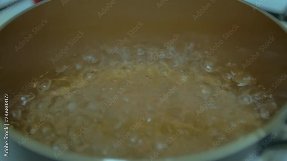 Close up water boiling in copper pot Close up water boiling in copper pot
