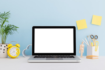 Laptop macbook screen on a bright blue background office workspace. Mock up.	