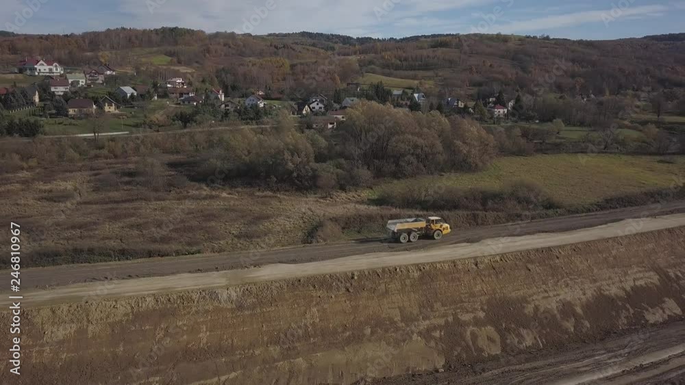 Strzyzow, Poland - may 2, 2018:A dump truck is loaded with soil. Land works in the quarry of river gravel. Extraction of natural resources. Work on a special technique produced by Strzyzow, Poland - may 2, 2018:A dump truck is loaded with soil. Land works in the quarry of river gravel. Extraction of natural resources. Work on a special technique produced by