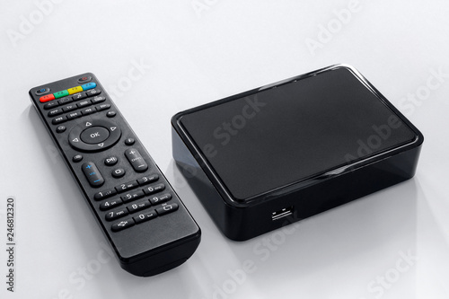 Iptv box and remote controller. Modern multimedia device for viewing television via the Internet, multimedia player and control panel.