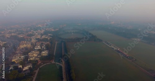 Bombay, India, Aerial flight over the horse riding ground and trraining areas, foggy weather of the city, traffic is going on the highway photo