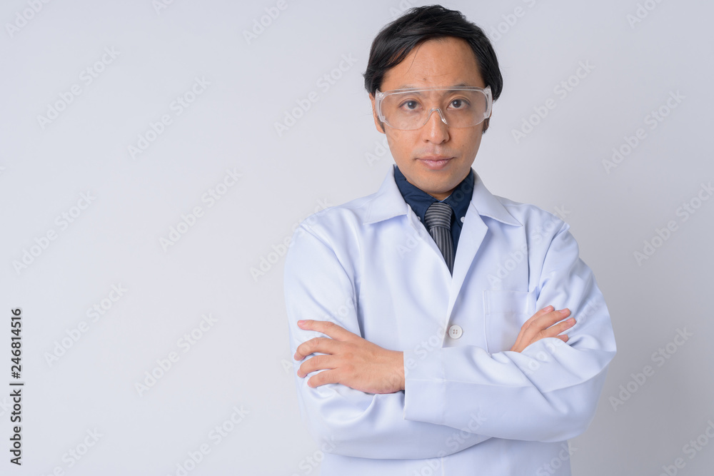 Japanese man doctor wearing protective glasses with arms crossed Japanese man doctor wearing protective glasses with arms crossed