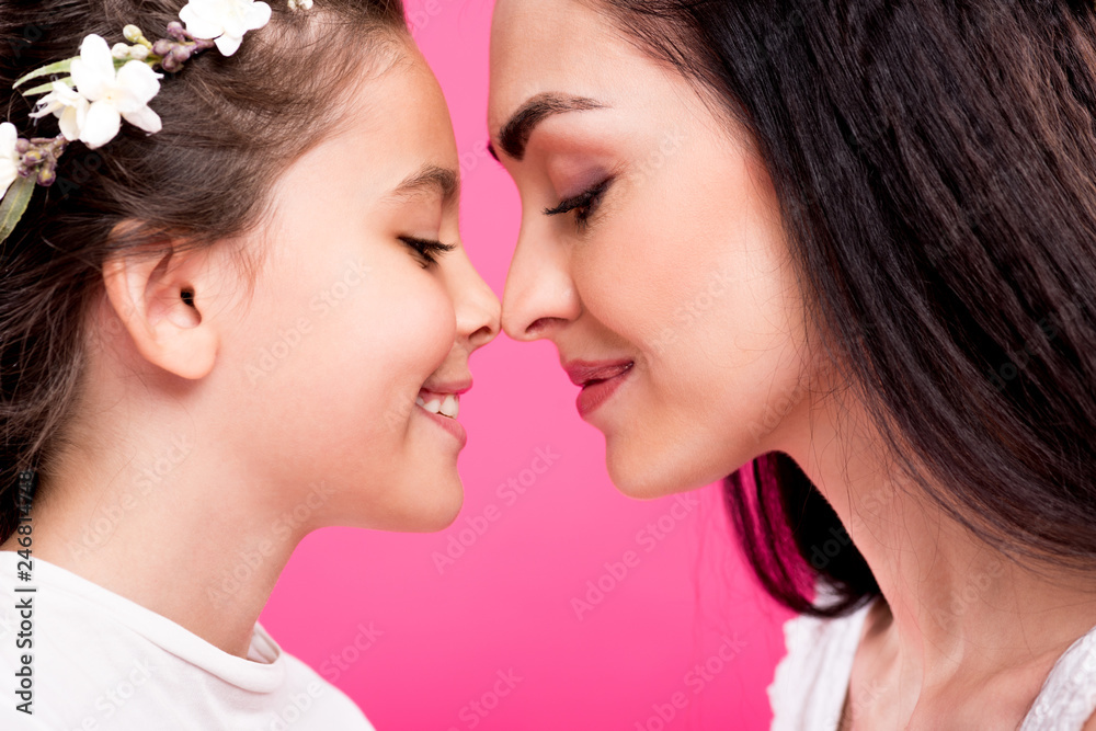 side view of beautiful happy mother and daughter isolated on pink side view of beautiful happy mother and daughter isolated on pink
