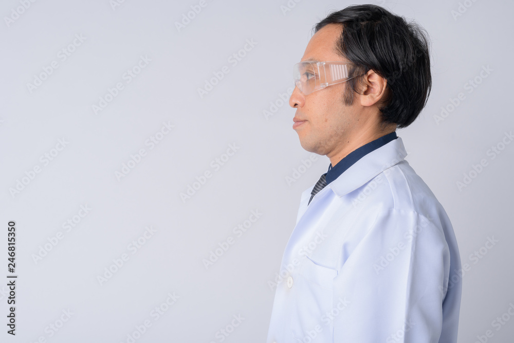 Profile view of Japanese man doctor wearing protective glasses Profile view of Japanese man doctor wearing protective glasses
