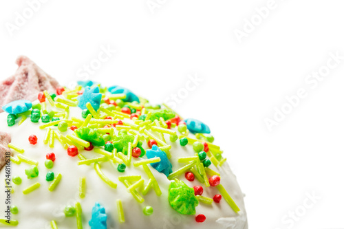 Top part of Easter cake with cream, colorful sugar sticks and drops