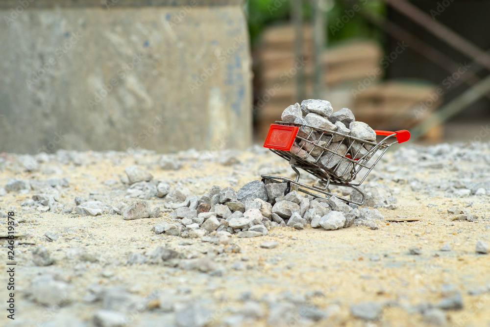 Selective focus on shopping trolley carries the crushed stones and pours onto the pile at the construction site Selective focus on shopping trolley carries the crushed stones and pours onto the pile at the construction site