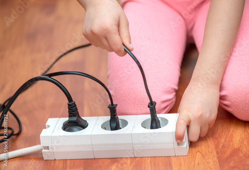 Little child playing with plug