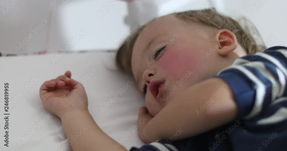 Adorable little boy sleeping in bed at home Adorable little boy sleeping in bed at home