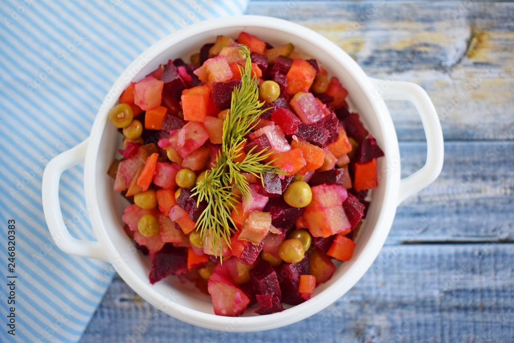 Vegetable salad with carrots and beets.Vinaigrette on a white plate.Vegetarian food. Vegetable salad with carrots and beets.Vinaigrette on a white plate.Vegetarian food.