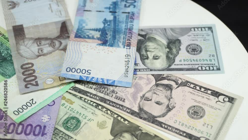 Indonesia money and US dollar on white background. 4K Indonesia money and US dollar on white background. 4K