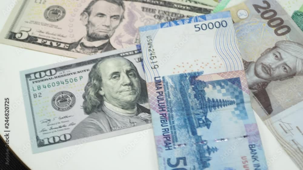 Indonesia money and US dollar on white background. 4K Indonesia money and US dollar on white background. 4K