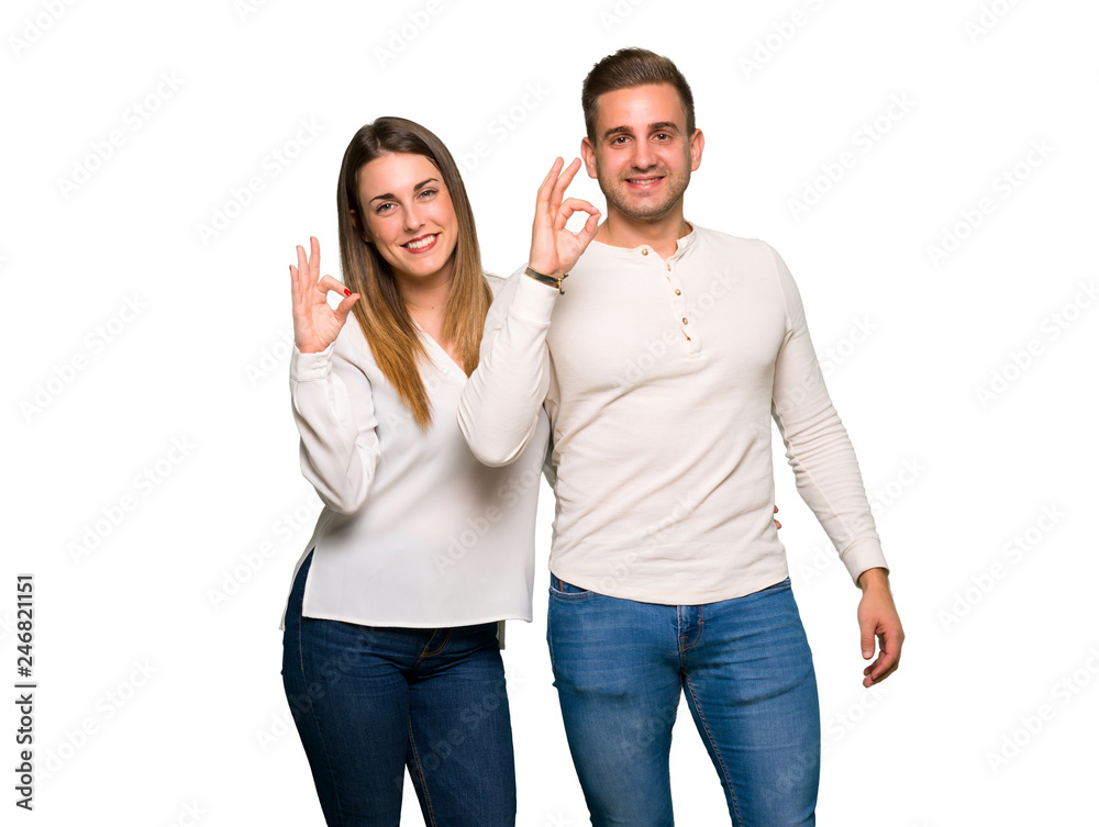 Couple in valentine day showing an ok sign with fingers Couple in valentine day showing an ok sign with fingers