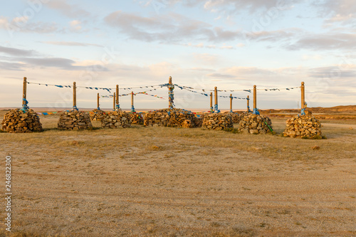 Mongolian Ovoo, Ceremonial Rock Pile on Mountain Top in Desert Steppes photo