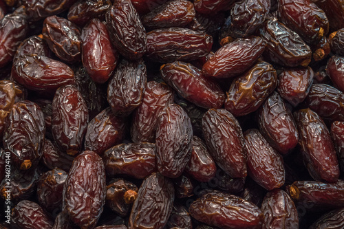 Close up food background of dried dates dark expressive texture, close up