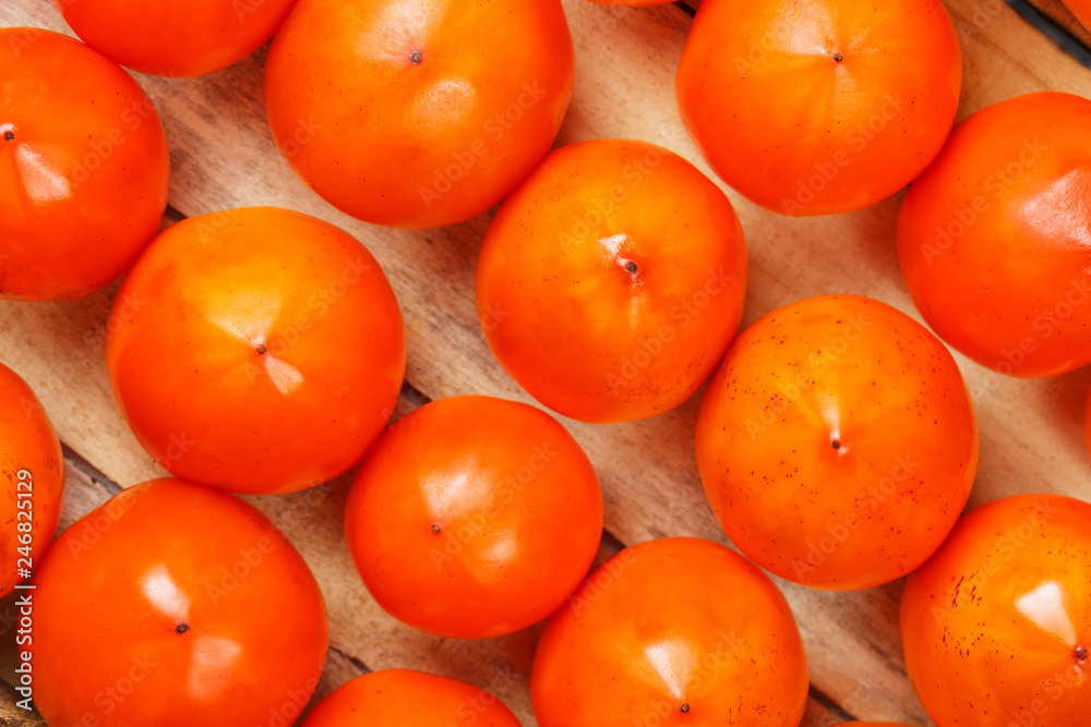 Fresh ripe persimmons in market. Persimmons background. Fresh ripe persimmons in market. Persimmons background.