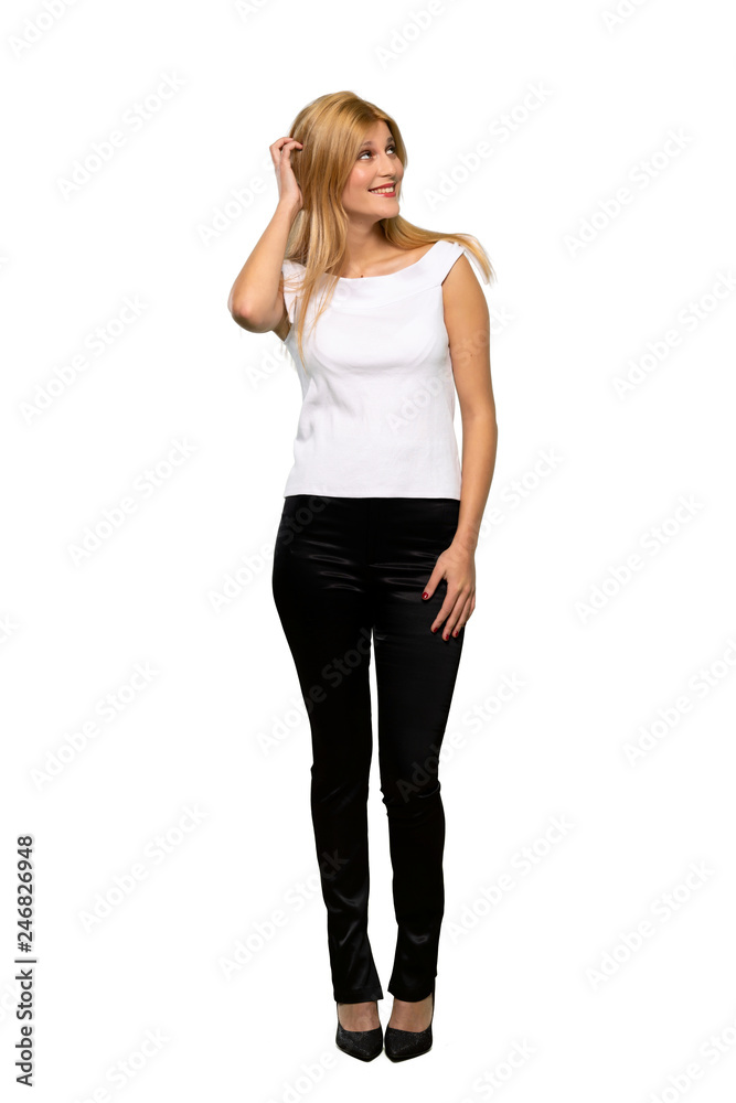 Young blonde woman thinking an idea while scratching head over isolated white background Young blonde woman thinking an idea while scratching head over isolated white background