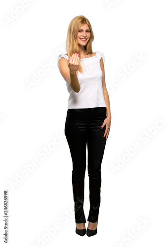 Young blonde woman inviting to come with hand. Happy that you came over isolated white background