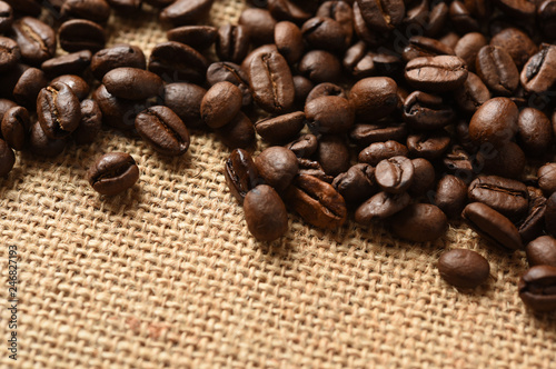 Closeup of coffee beans on burlap background