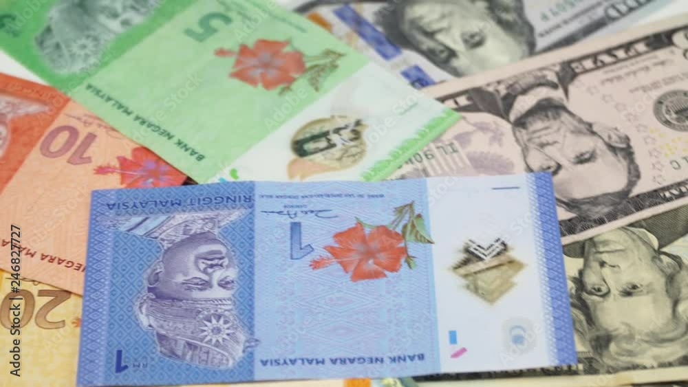 US dollar and Malaysia money on the table rotating. 4K