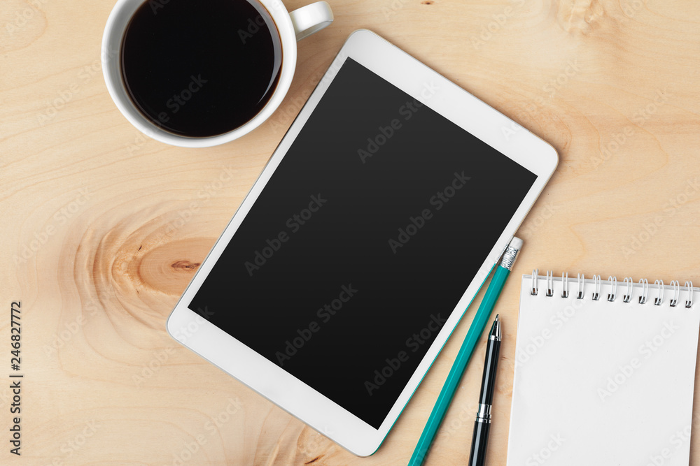 Digital tablet computer and cup of coffee on wooden desk. Digital tablet computer and cup of coffee on wooden desk.