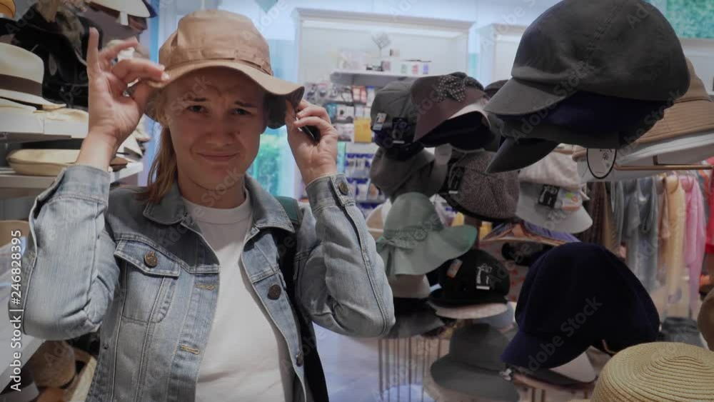 Young Caucasian Female Shopping in Hat Store Young Caucasian Female Shopping in Hat Store