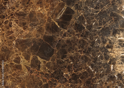 Textured dark brown marble stone with white spots