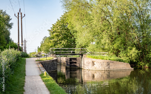 English canal lock and tow path, Hertfordshire, England. A spring rural  canal scene on the River Lee Navigation, near Cheshunt, north of London.