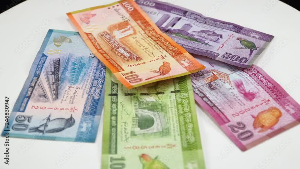 Sri Lankan money. White background on the desk. 4K Sri Lankan money. White background on the desk. 4K