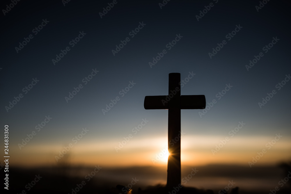 Silhouette of catholic cross and sunrise