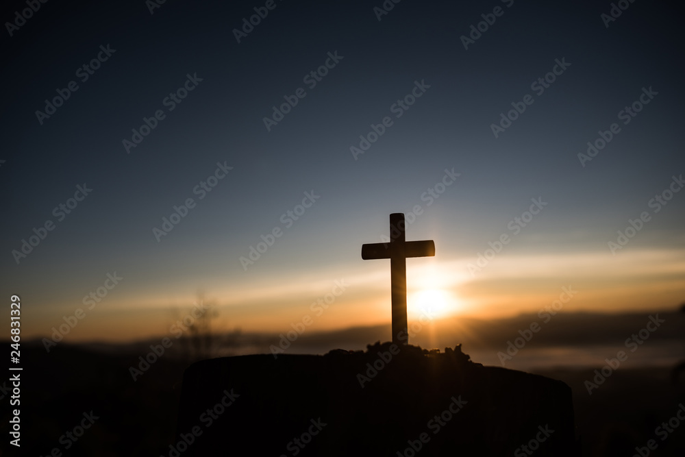 Silhouette of catholic cross and sunrise - obrazy, fototapety, plakaty 
