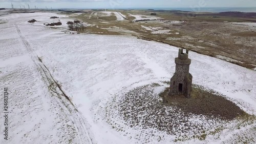 Aerial footage of St Johnstons Mount monument in the snow on a winters day in Aberdeenshire, Scotland photo