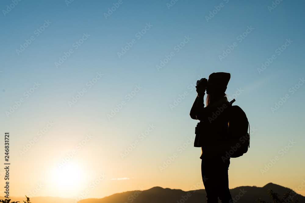 Silhouette of tourist woman standing in the mountain