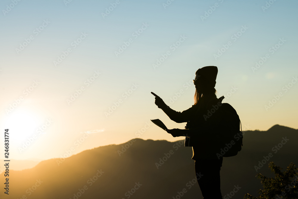 Silhouette of tourist woman standing in the mountain