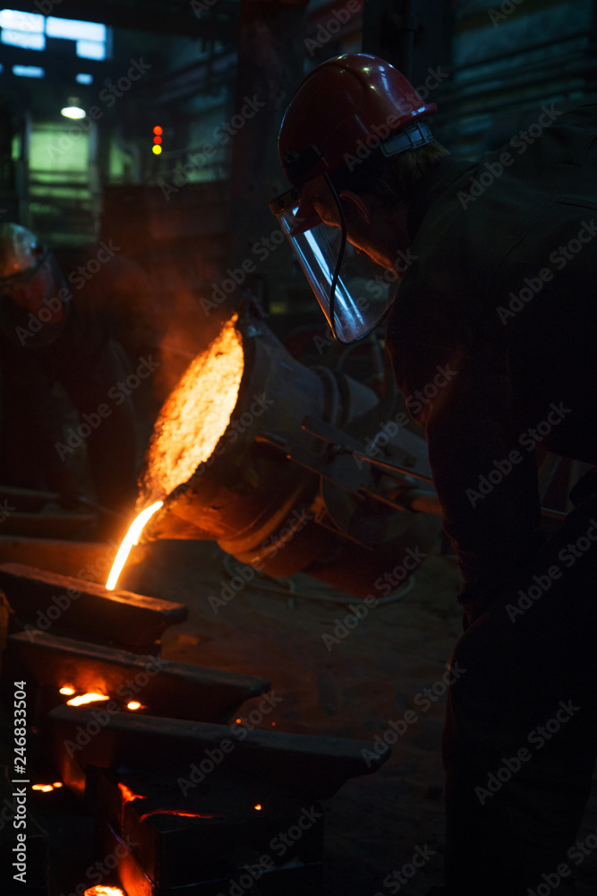 Worker of foundry production. The burning metal