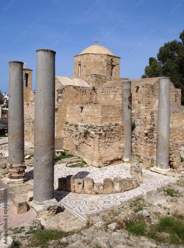 the historic church of yia Kyriaki Chrysopolitissa in paphos cyprus showing the building and the surrounding old roman columns and ruins
