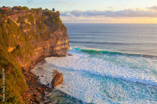 Travel vacation on exotic islands background - Sunset on the ocean coast with rocks beach Bali Indonesia with Waves and cliffs 