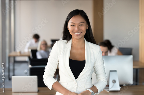 Smiling Young Asian Business Woman Looking At Camera Happy Chinese Employee Worker Team Leader Coach Or Corporate Manager Posing In Office Millennial Korean Professional Head Shot Portrait Stock Photo Adobe Stock