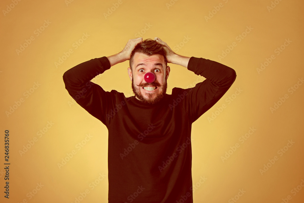 The happy surprised and smiling man on red nose day. The clown, fun, party, celebration, funny, joy, holiday, humor concept