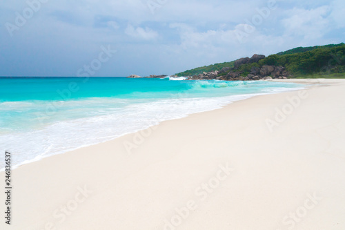 The beach on the Seychelles with white sand turquoise water and blue sky © 25ehaag6