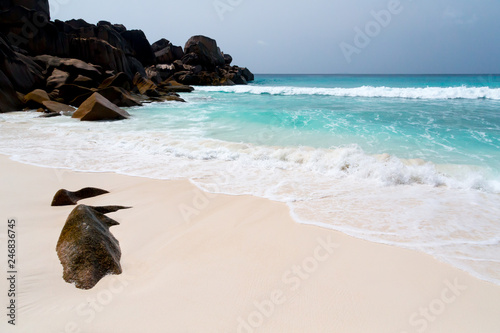 Big rocks on the beach with white sand