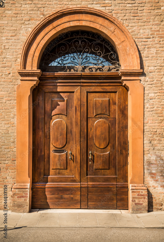 Old house wooden door in Ferrara, Italy